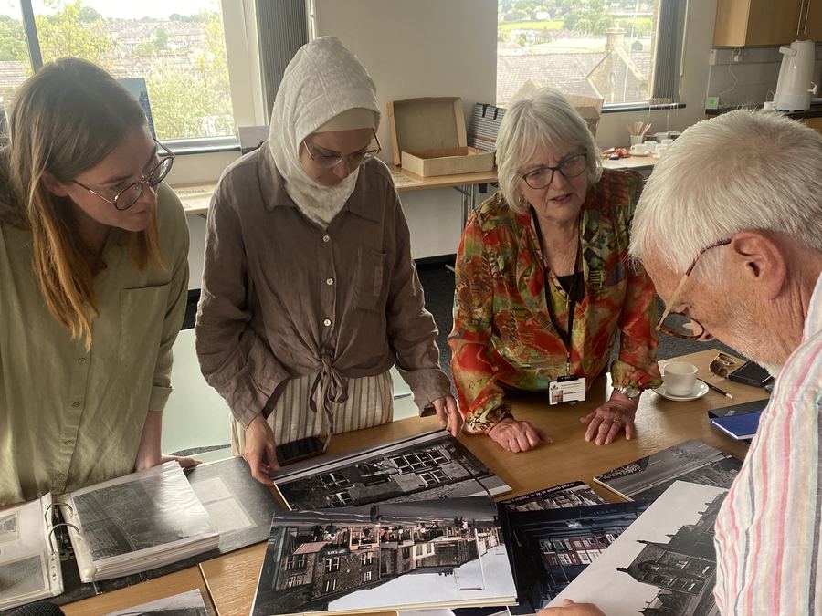 Community members reviewing local heritage photographs