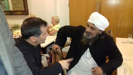 Vicar and faith leader sharing a conversation